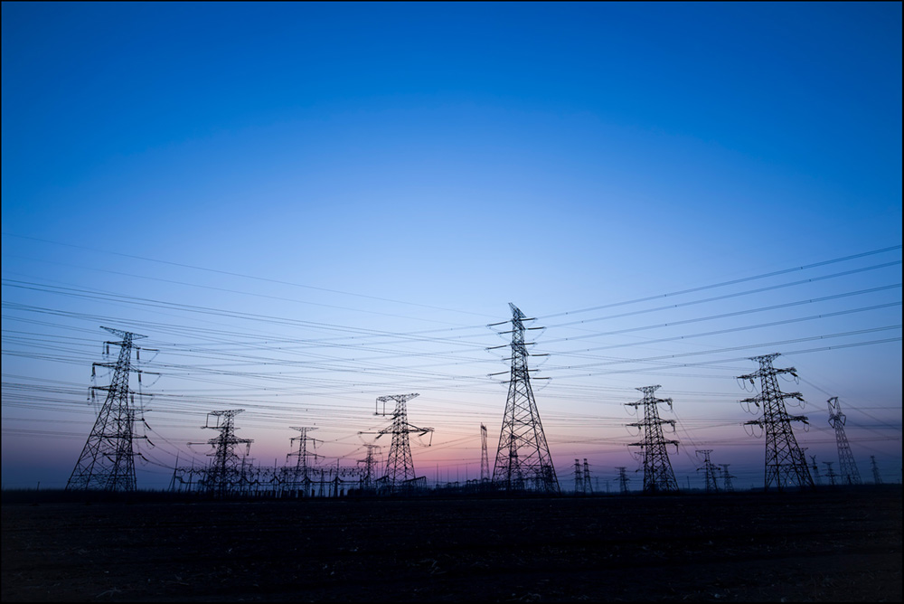 Transmission lines at dusk with ground perspective