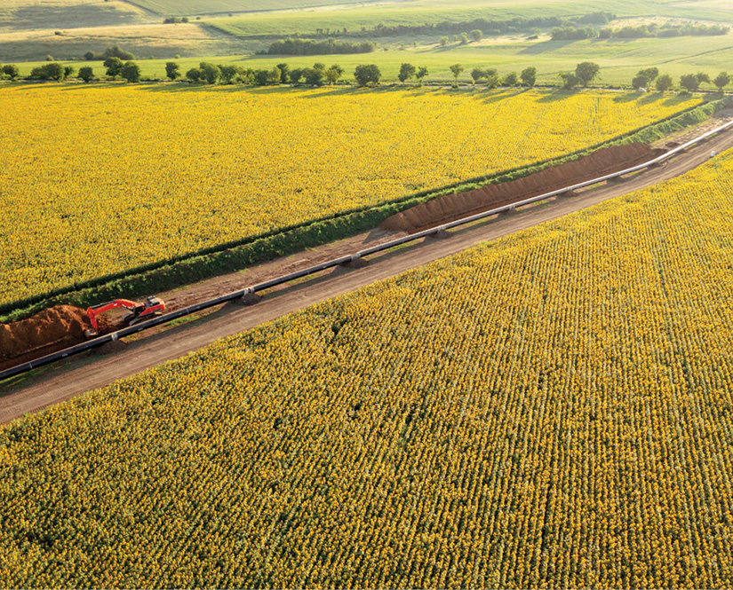 Pipeline going through field and being laid down