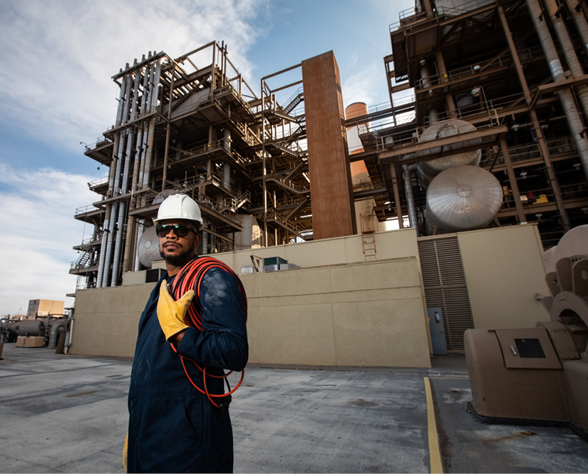 Person with Hard hat in front of LNG Facility