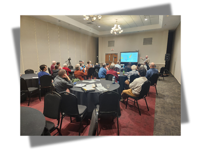Image of a conference room with people looking at a presentation